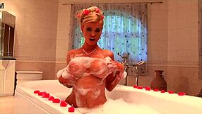 HUGE-TITTED BLONDE MILF POUNDS SHAVED PUSSY IN OILED JACUZZI